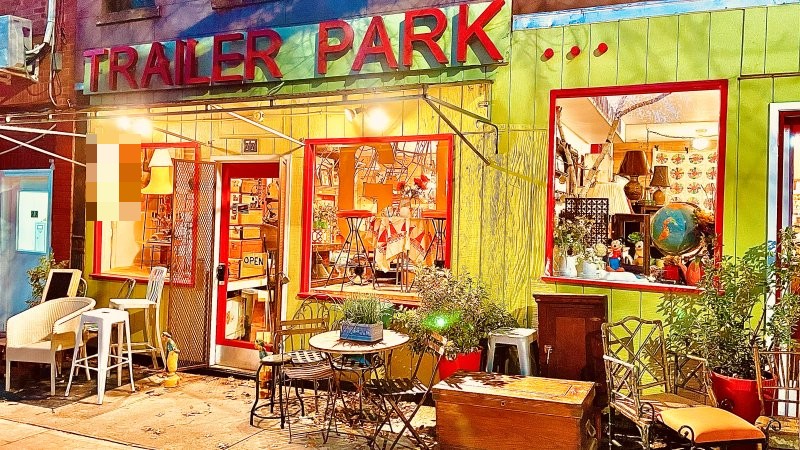 Lime-green Trailer Park storefront at night