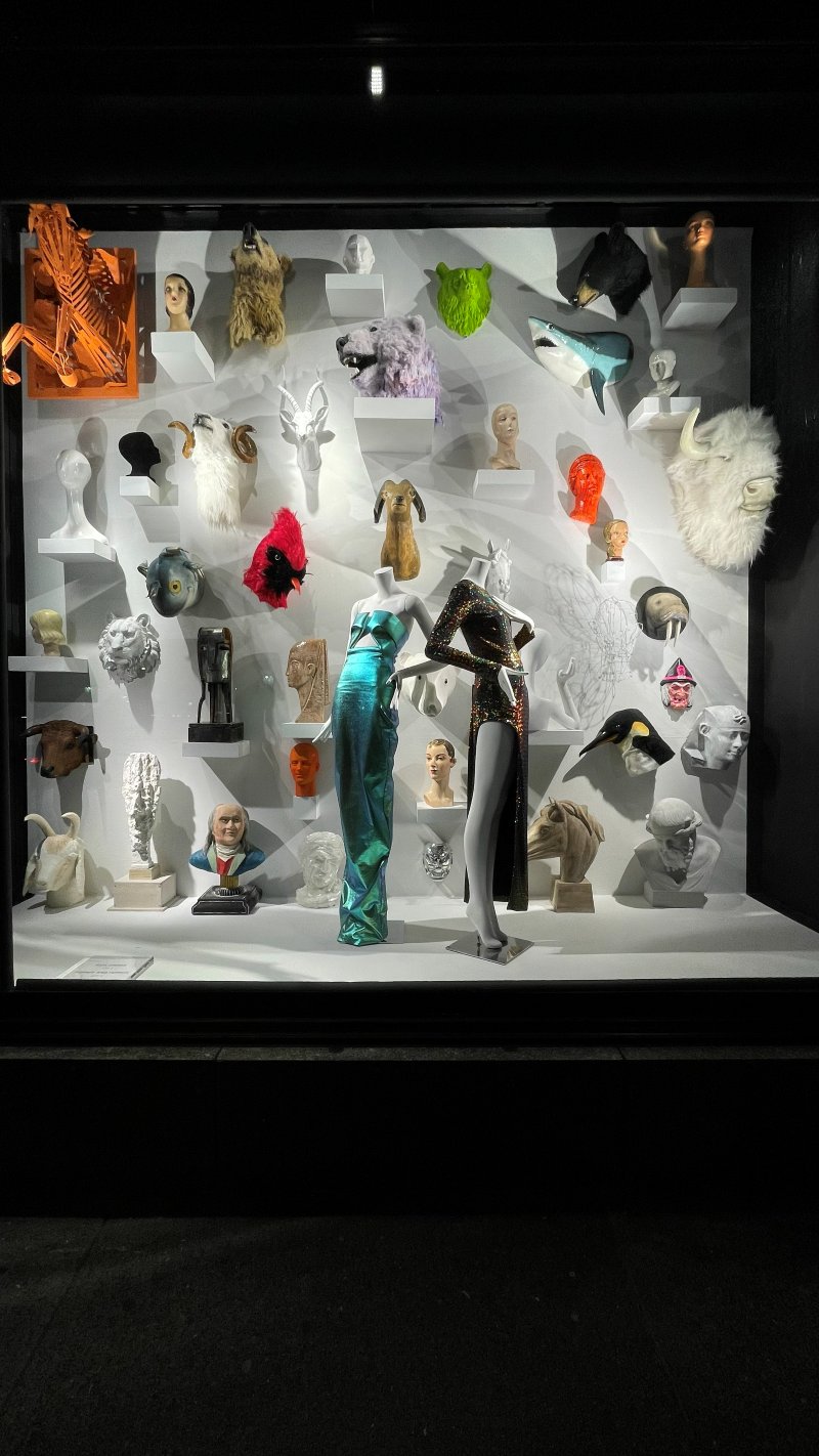 Night retail window with white animal sculpture wall